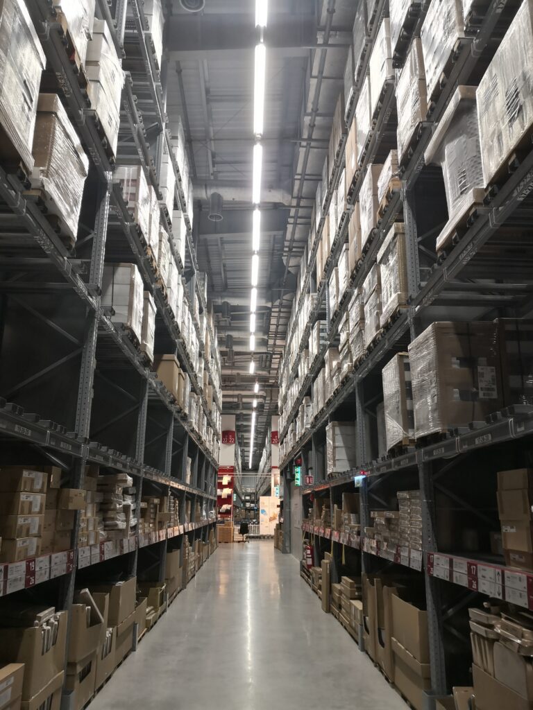 Tall warehouse storage racks holding packaged inventory.