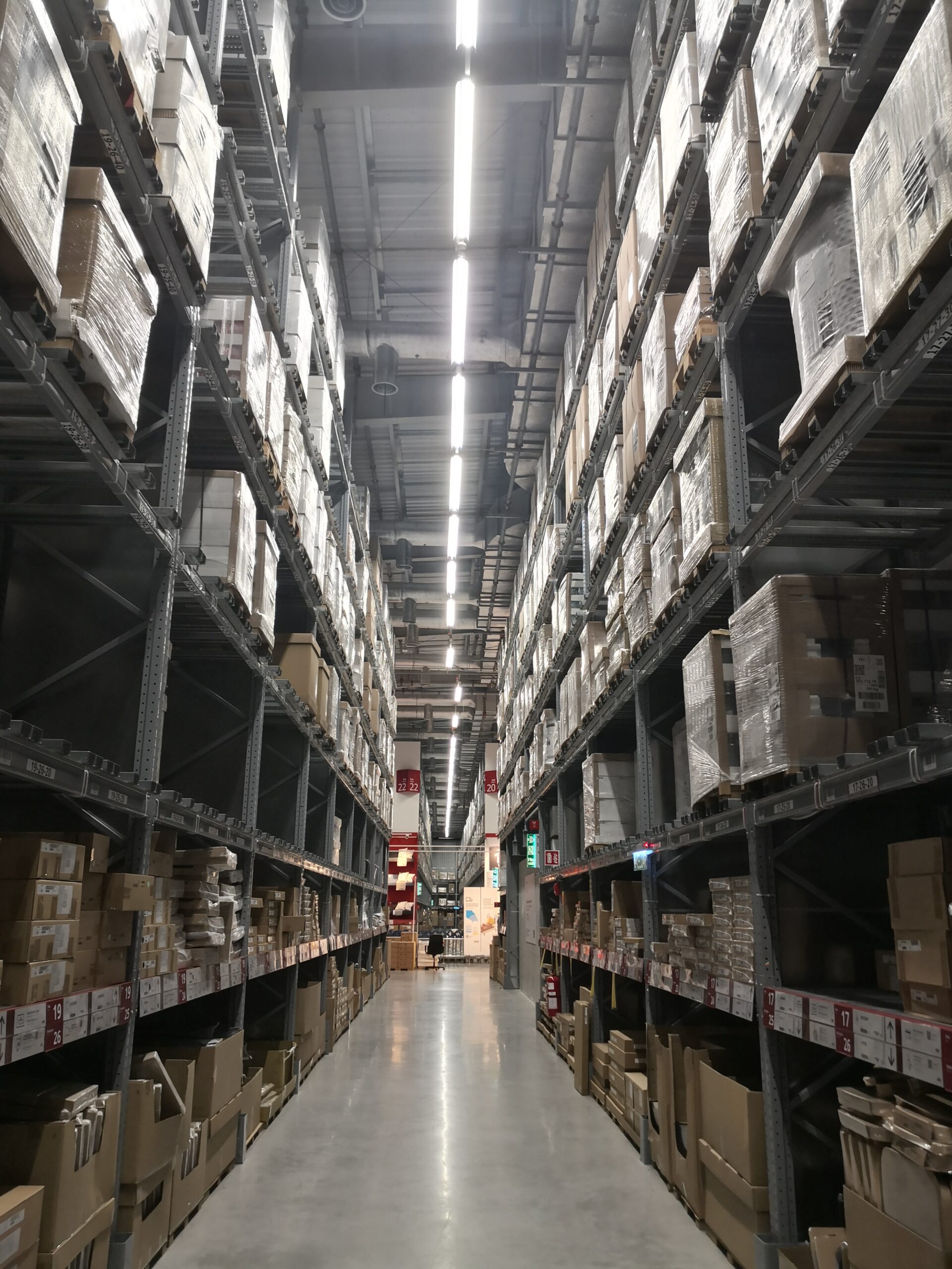 Tall warehouse storage racks holding packaged inventory.